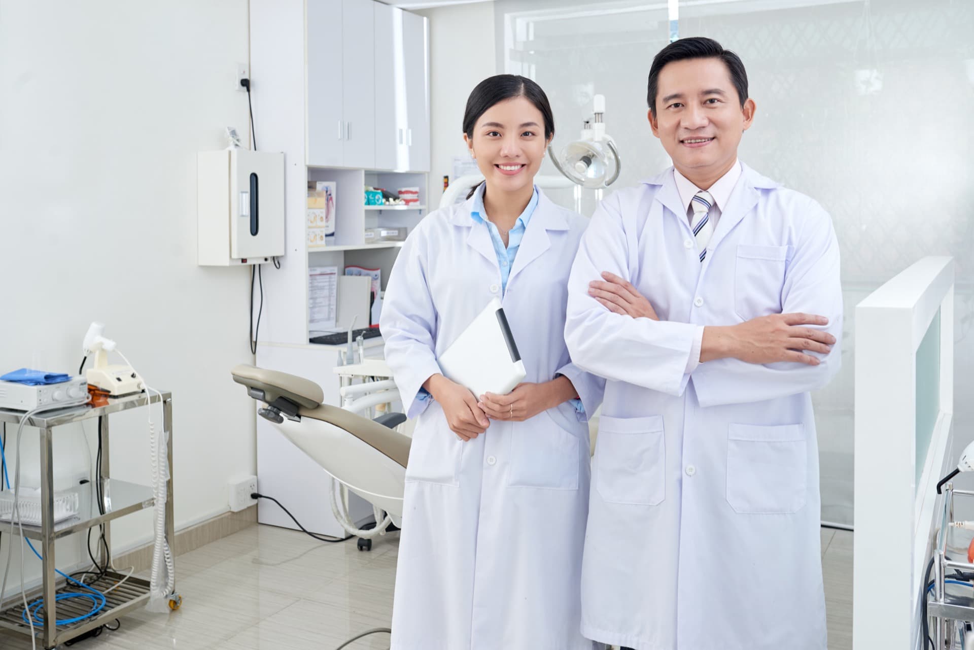 Clinic team working together beside a dental chair